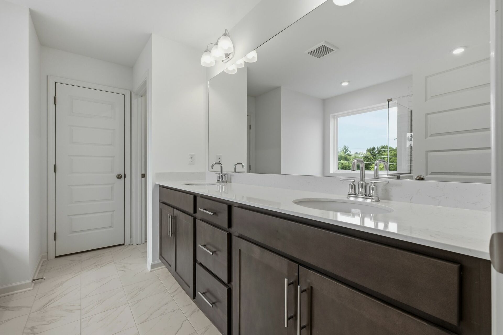 primary bathroom with large double-sink vanity, tub and shower