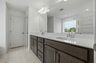 primary bathroom with large double-sink vanity, tub and shower
