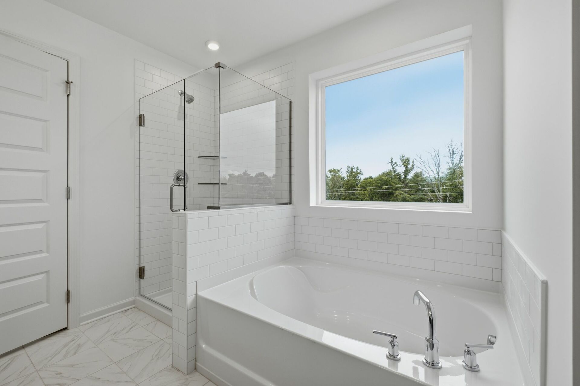 primary bathroom with large double-sink vanity, tub and shower