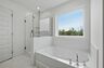 primary bathroom with large double-sink vanity, tub and shower