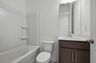 secondary bath with large mirror and tub 