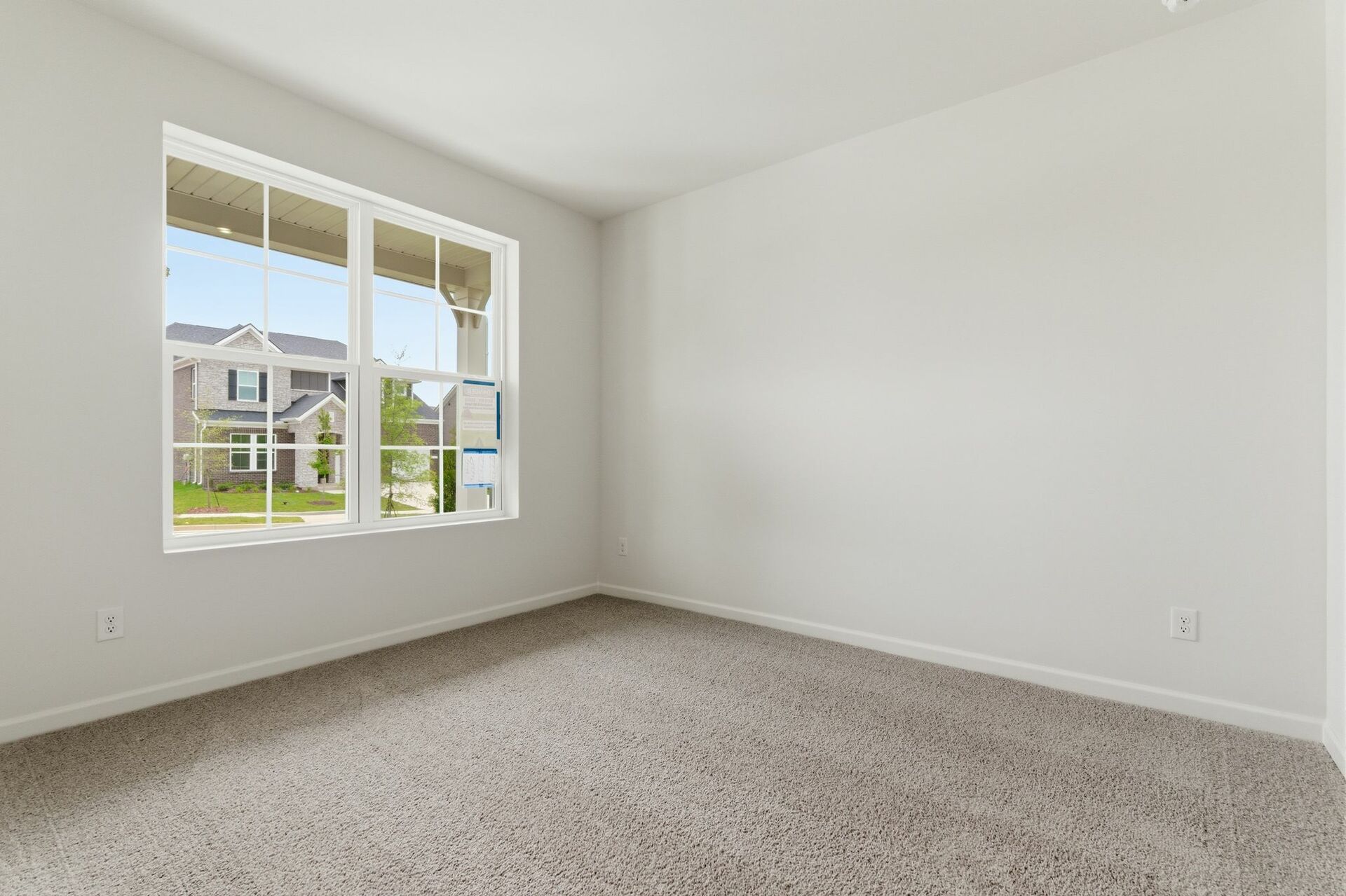 bedroom with carpet and large windows