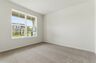 bedroom with carpet and large windows