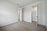 secondary bedroom with carpet, two large windows, and walk in closet