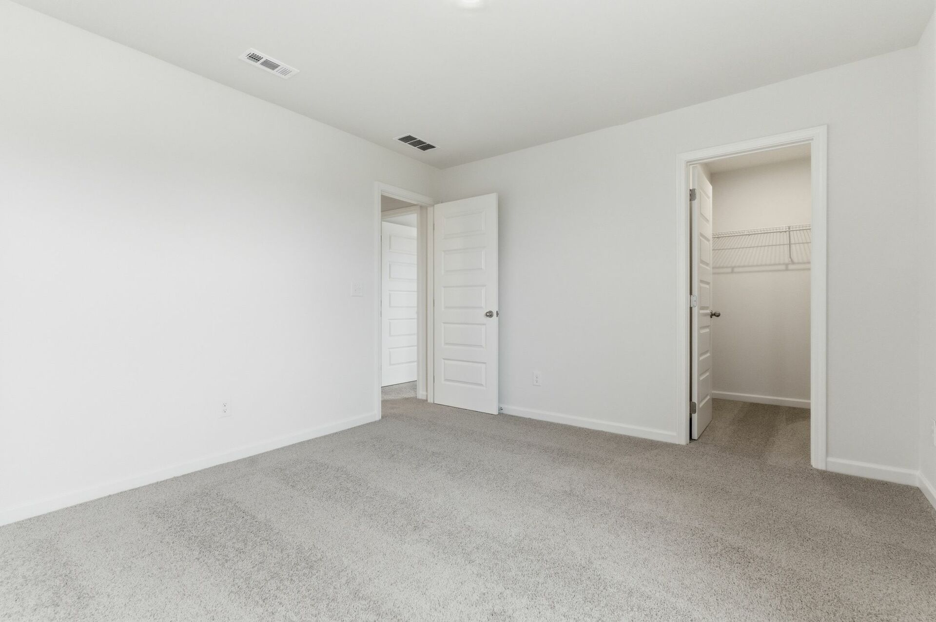 Secondary bedroom with carpet and large windows