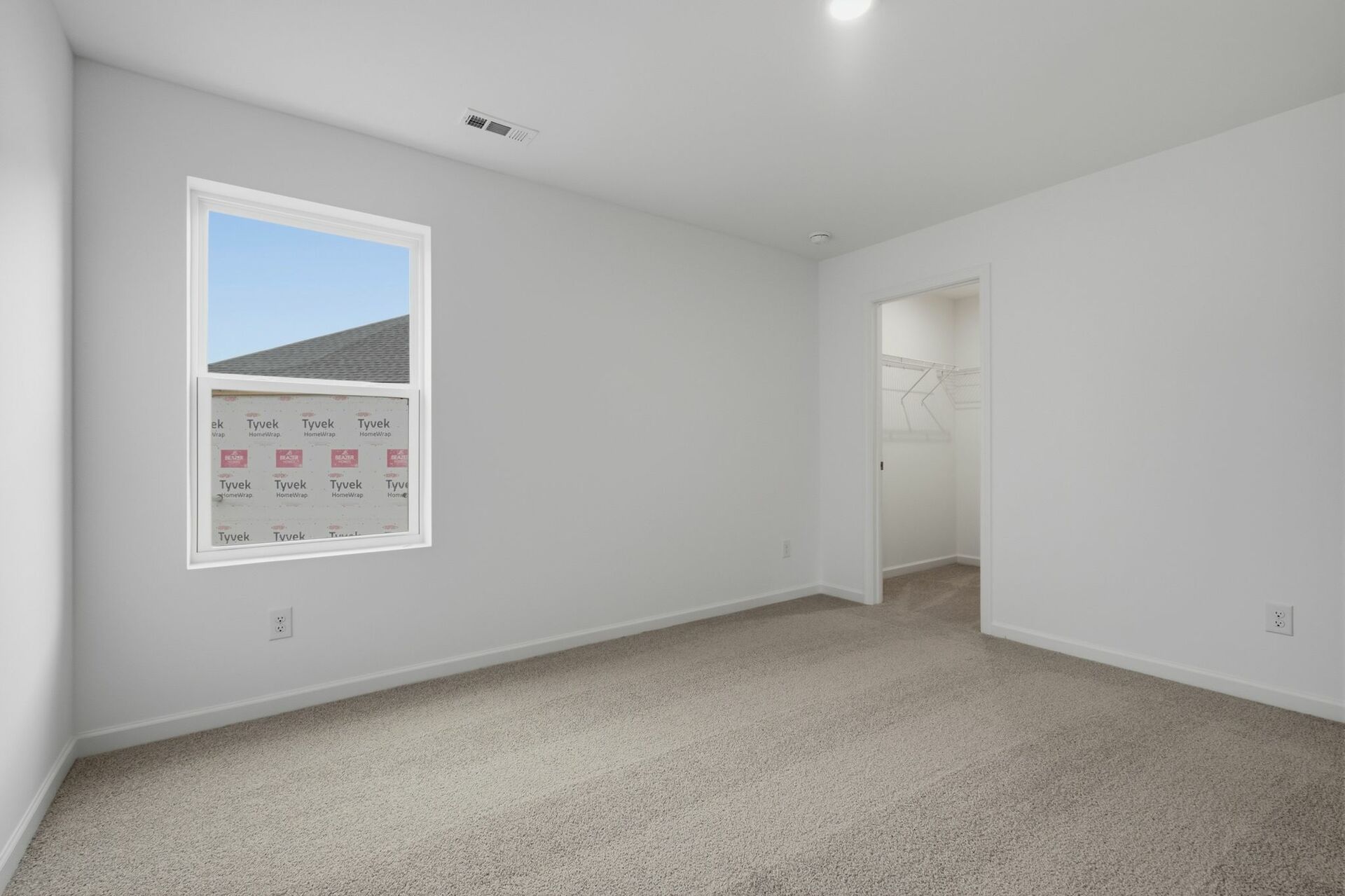 bedroom with carpet and large windows