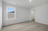 bedroom with carpet and large windows