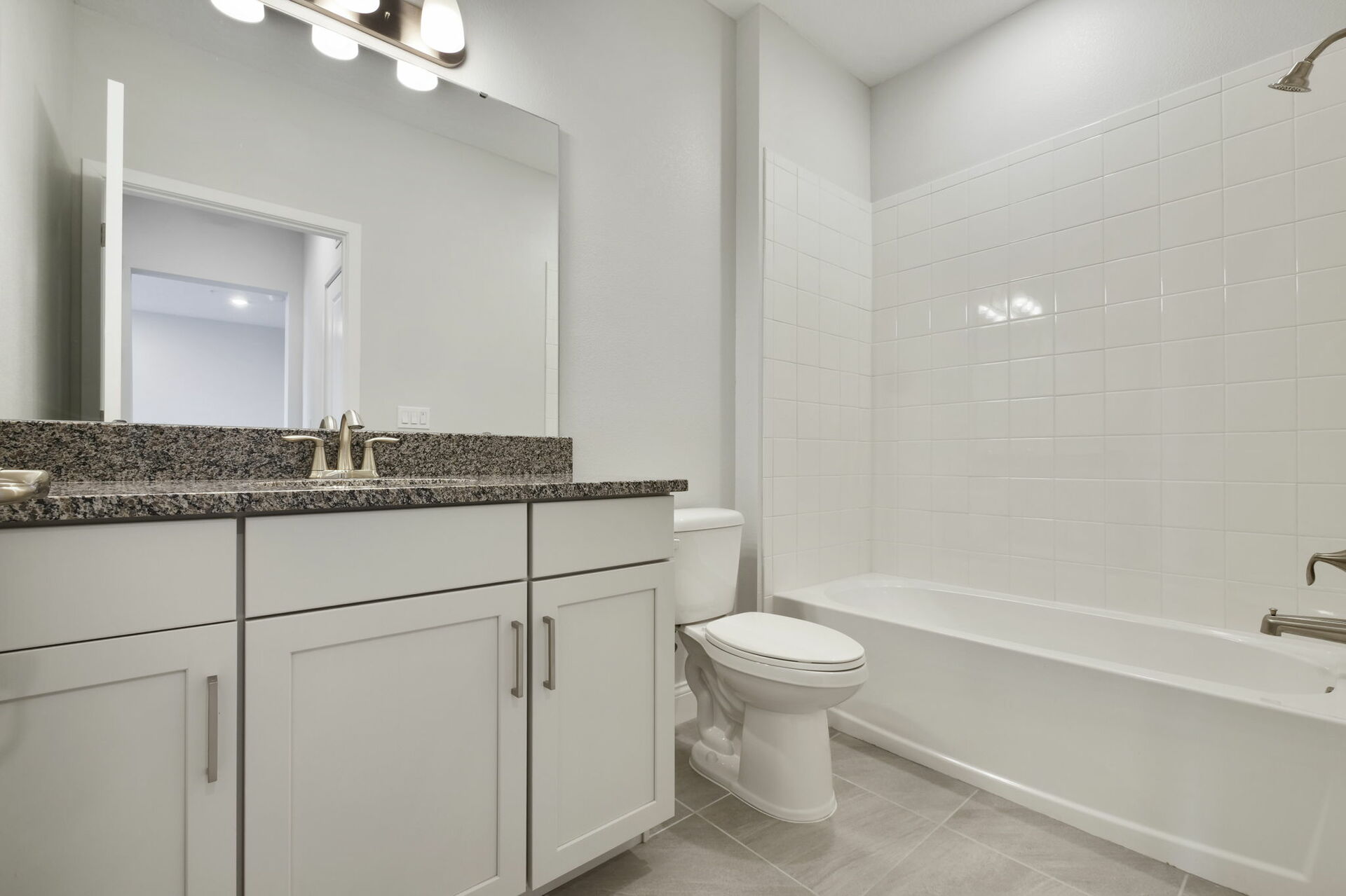 single sink vanity with water closet and shower