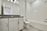 single sink vanity with water closet and shower