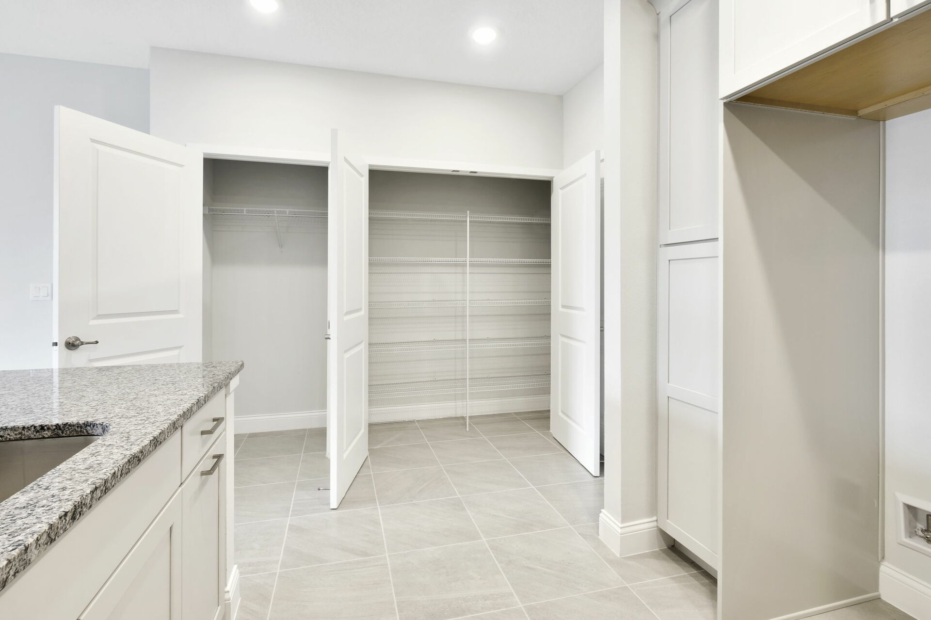 front entrance with kitchen pantry and storage closet 