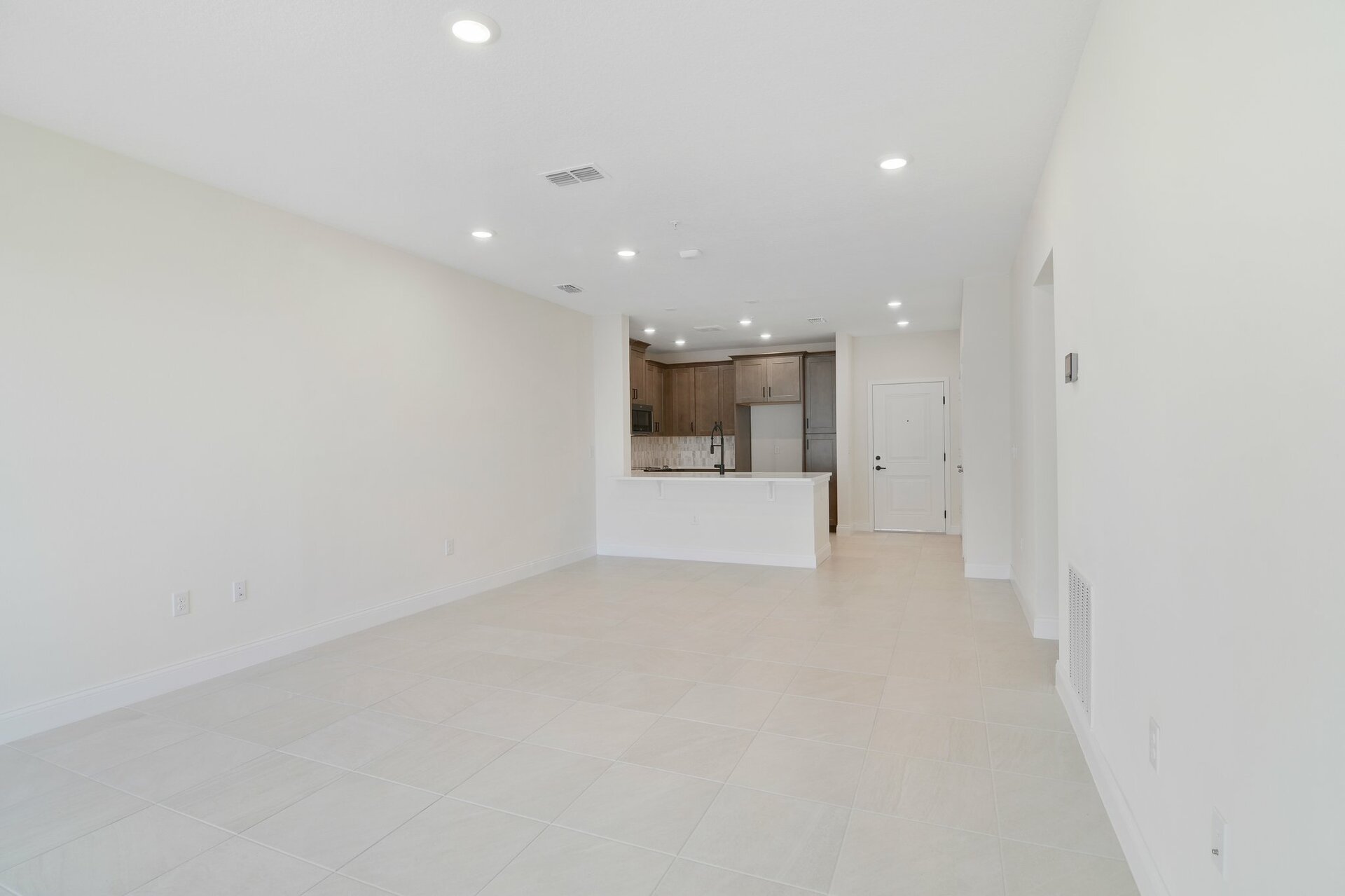 great room with tile flooring and sliding door leading to balcony