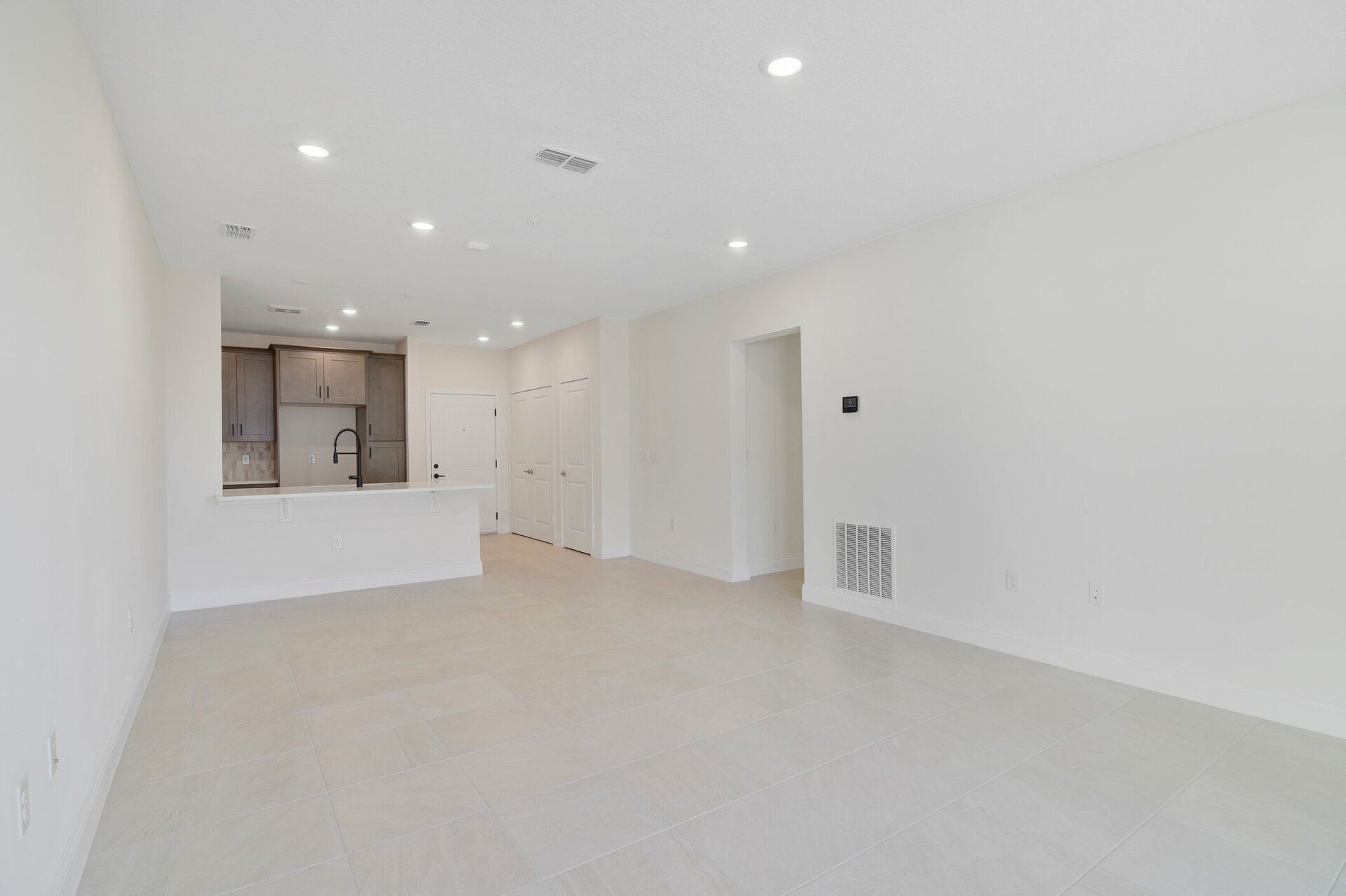great room with tile flooring and sliding door leading to balcony