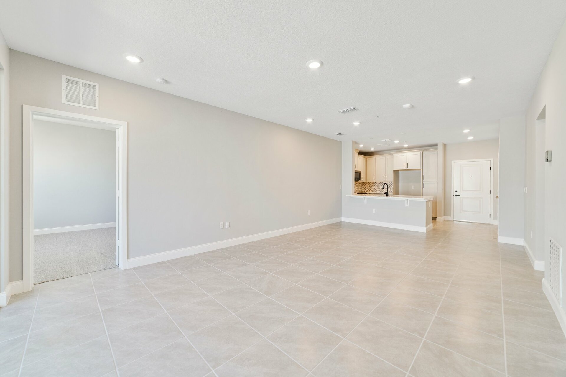 great room with tile flooring and slider leading to balcony