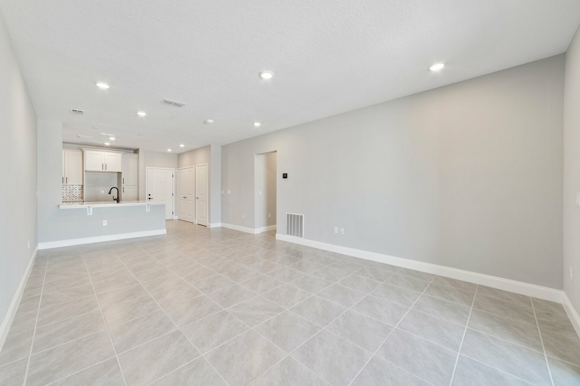 great room with tile flooring and slider leading to balcony