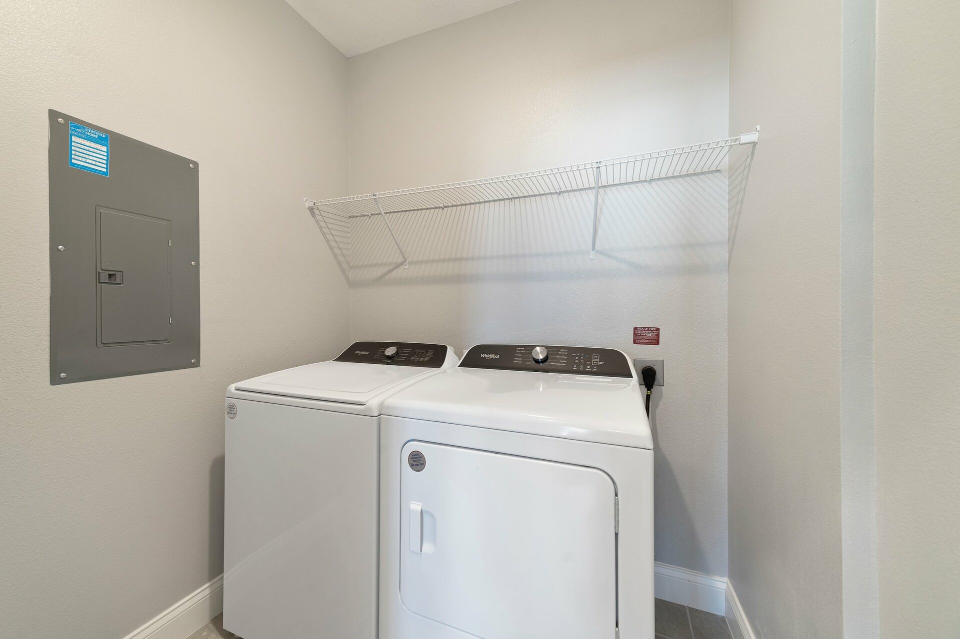 laundry room with washer, dryer, and wire shelving