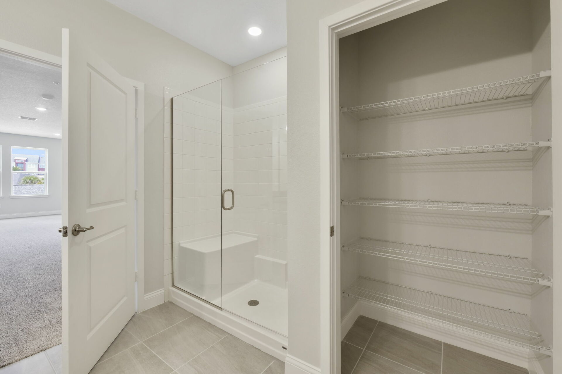 dual sink vanity with large mirror, water closet and shower