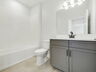 single sink vanity, water closet and shower