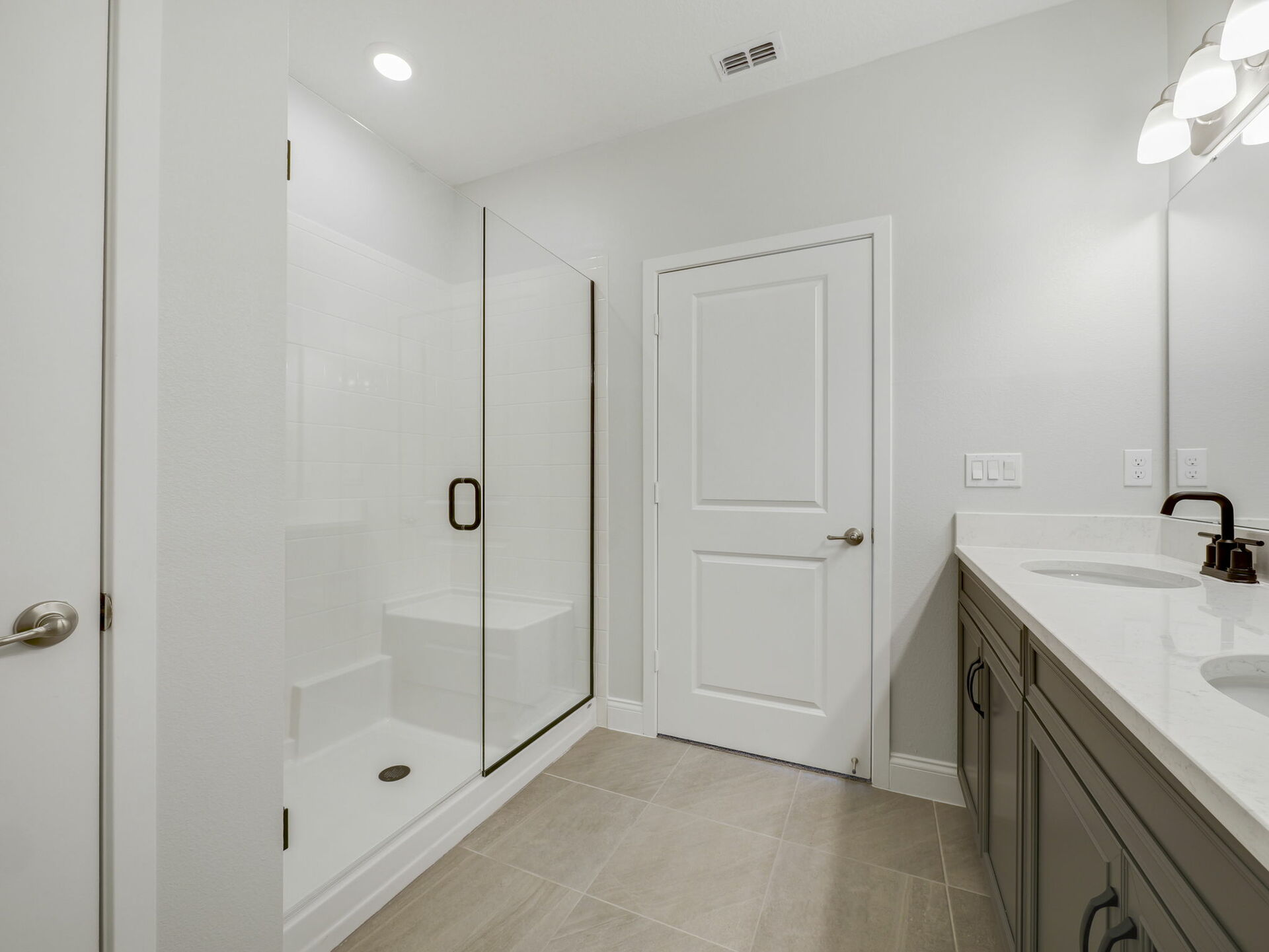dual sink vanity with water closet and semi-frameless shower 