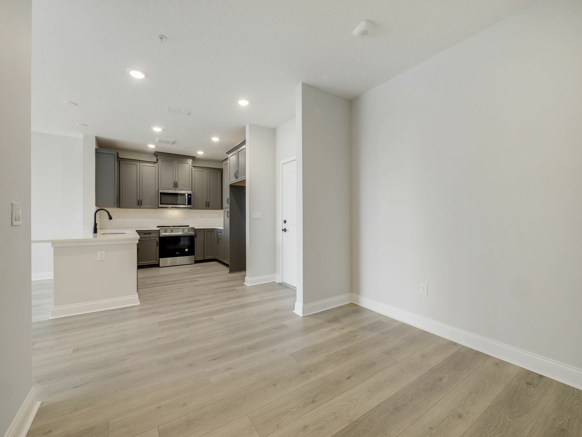 room with view of kitchen and front entrance