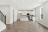 dining room with wood flooring, a view of the kitchen, and open to the great room