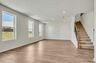 great room with wood flooring and large windows