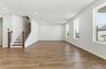 great room with oak wood staircase, and large windows
