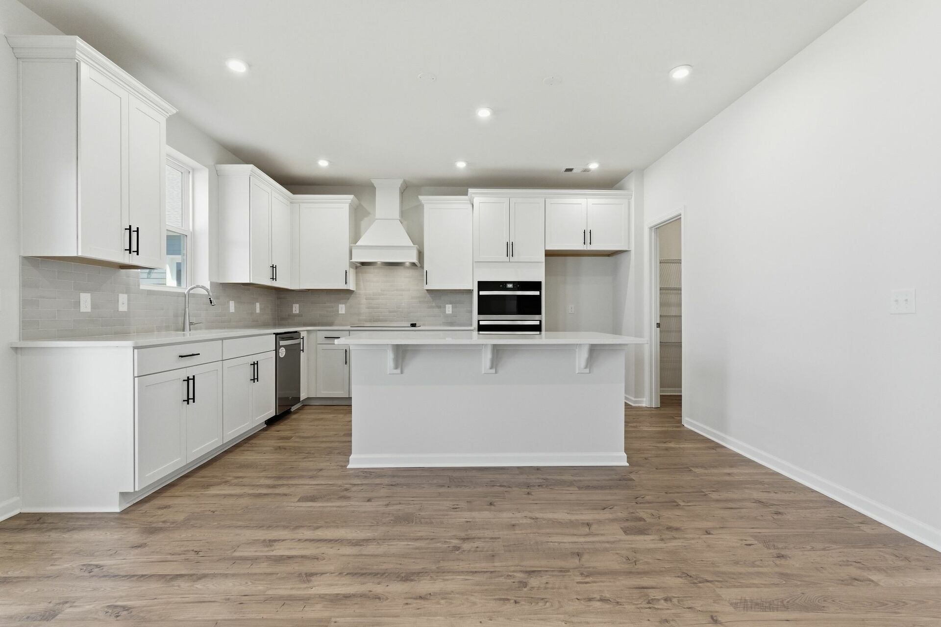kitchen with white cabinets and large island