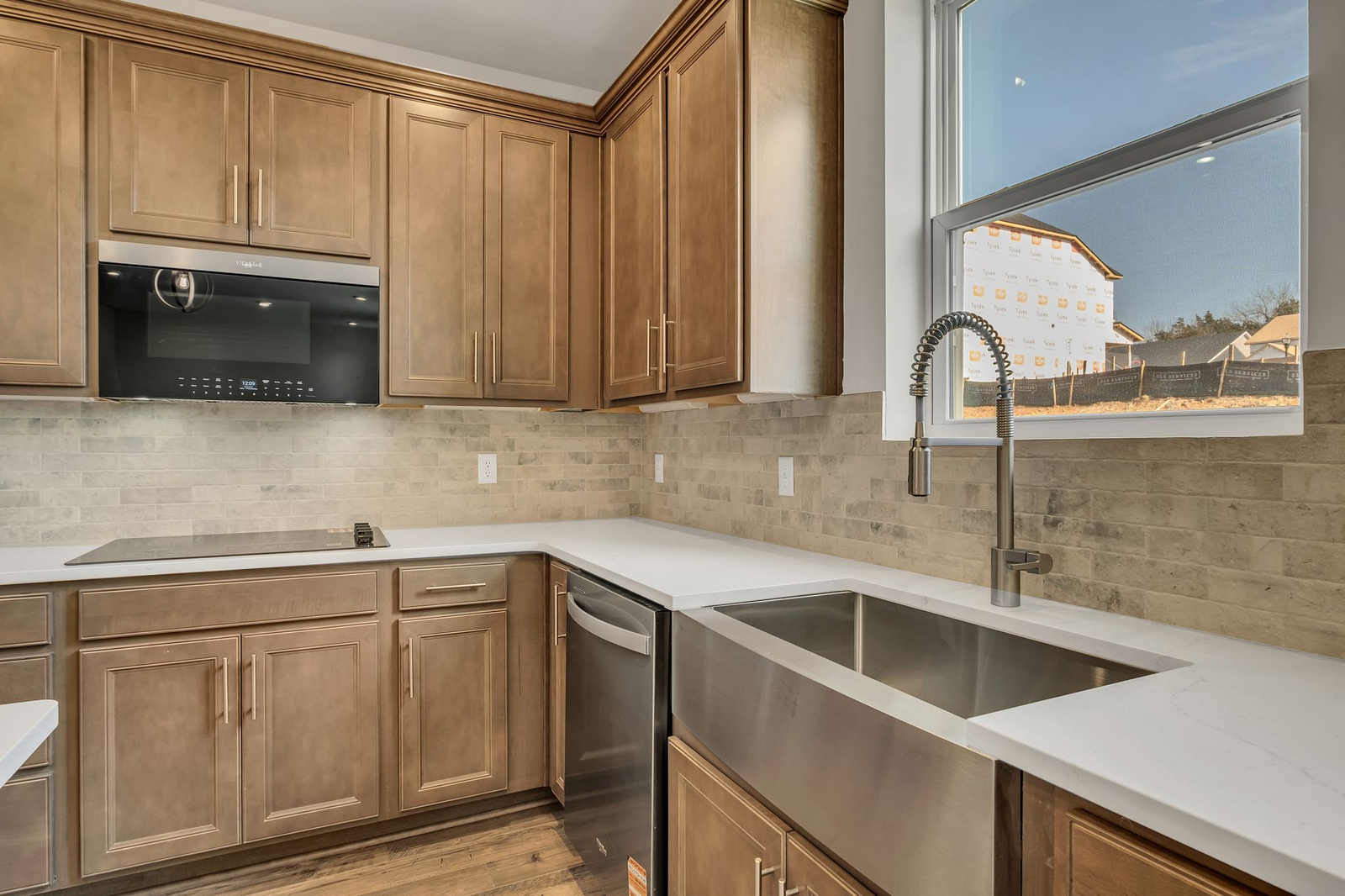 kitchen with wood cabinets, white countertops, and stainless steel appliances
