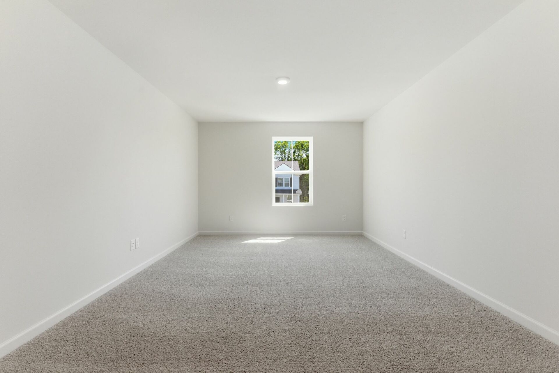 upstairs loft with large windows and carpet