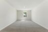 upstairs loft with large windows and carpet
