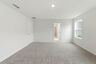 primary bedroom with carpet flooring, white trim, and large windows
