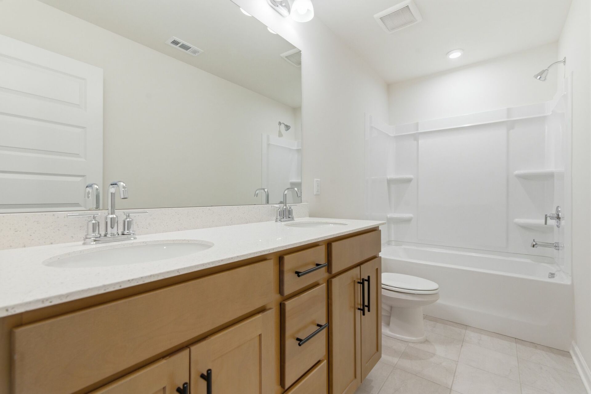 bathroom with dual vanity sinks and wood cabinets