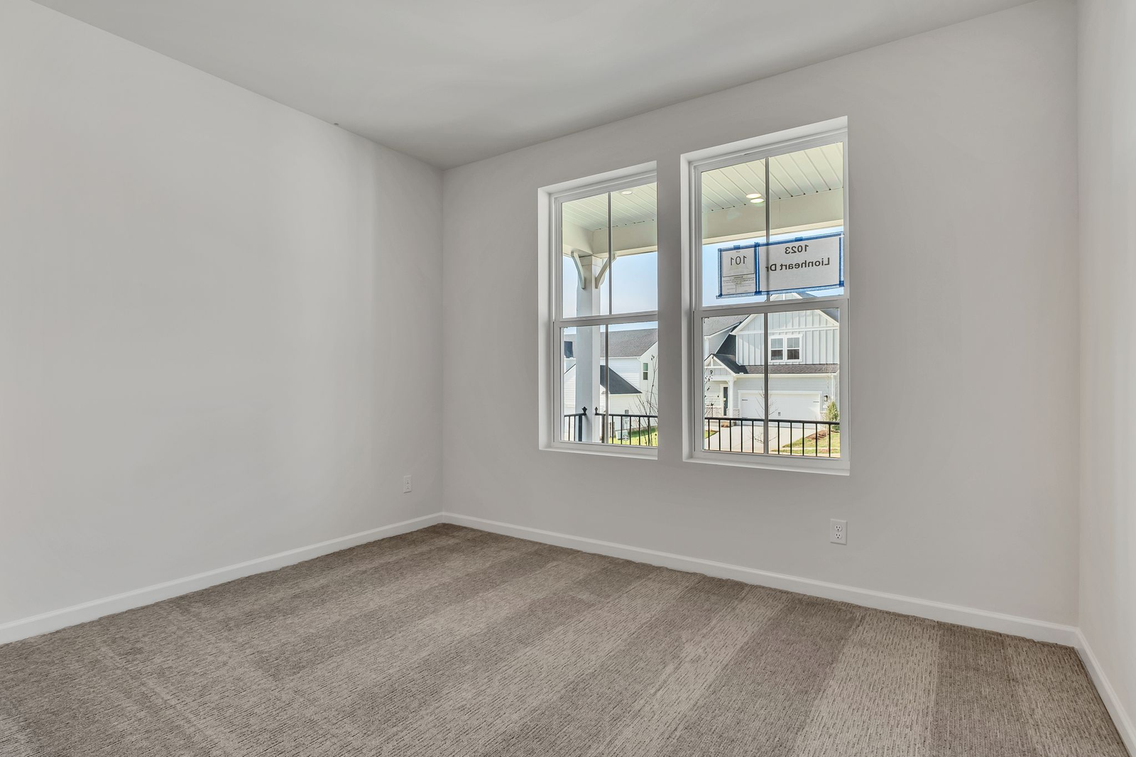 secondary bedroom with carpet flooring and large window