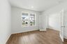 study with wood floors, large windows, and french doors