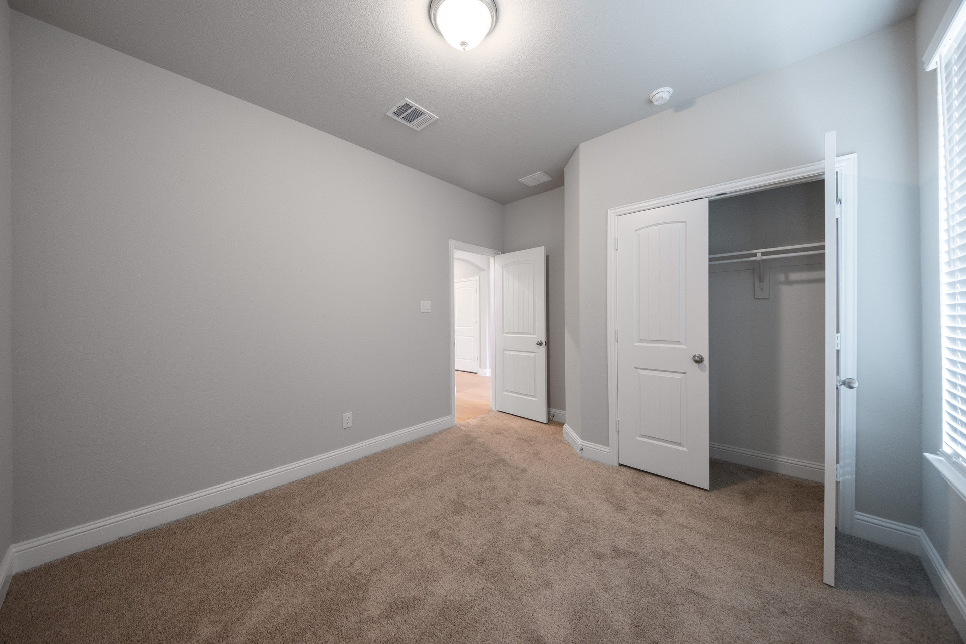 guest bedroom with carpet and walk-in closet