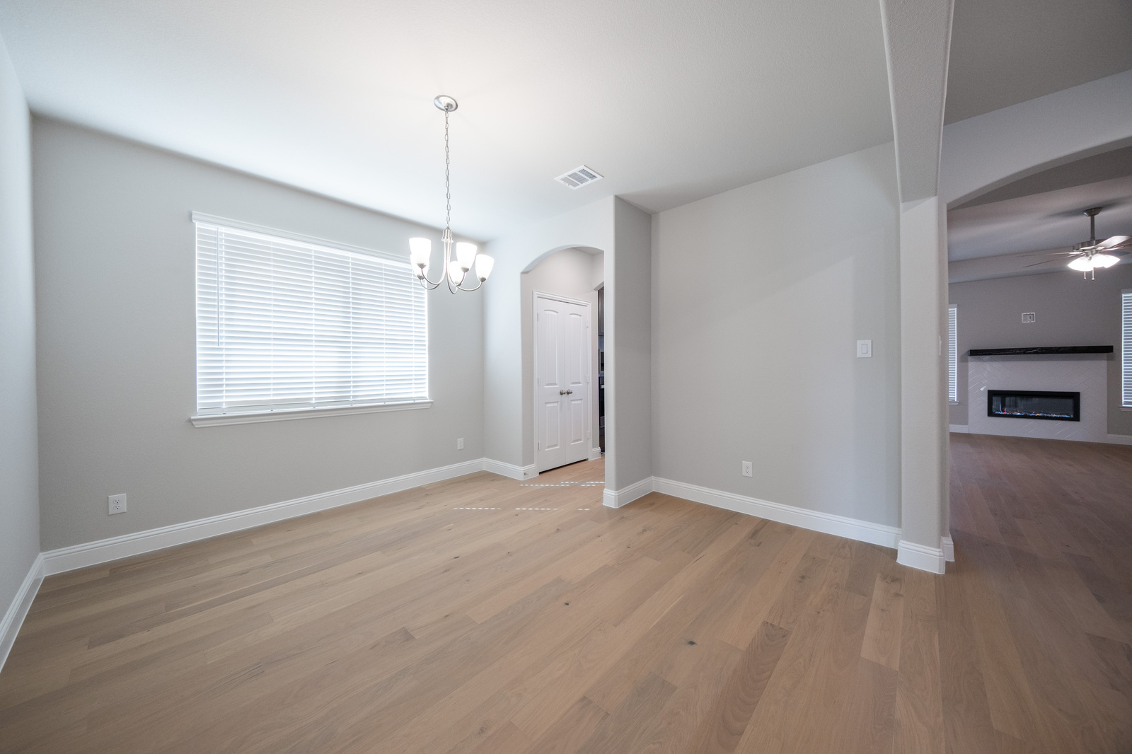 open dining room with hardwood flooring and windows