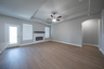 open great room with electric fireplace and hardwood flooring