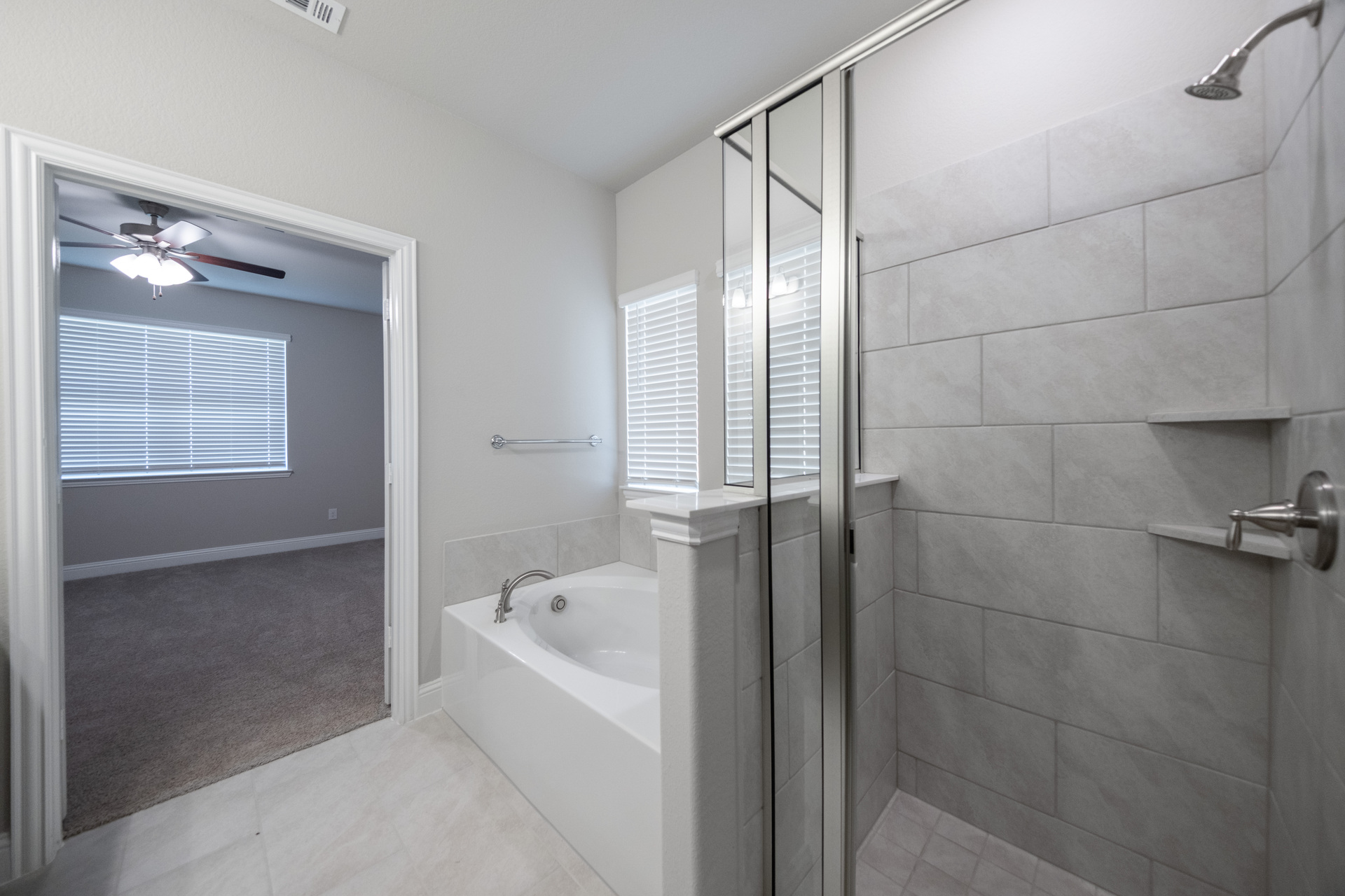primary bathroom with separate walk-in shower and soaking tub
