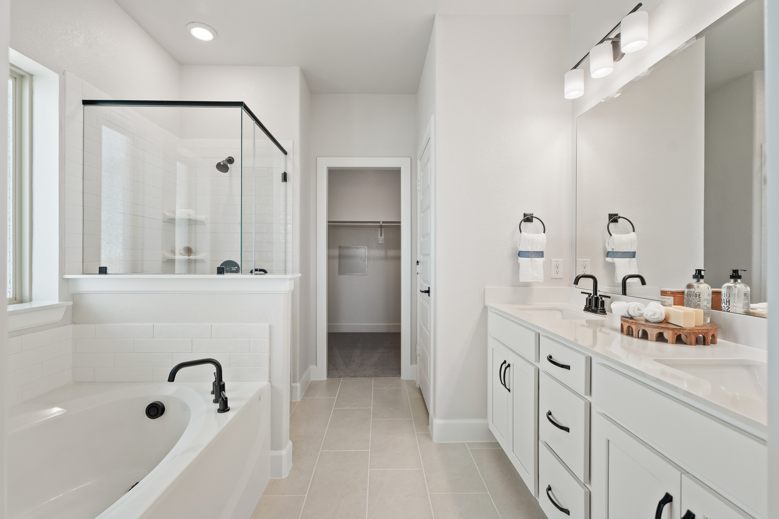 primary bathroom with tub and walk-in shower