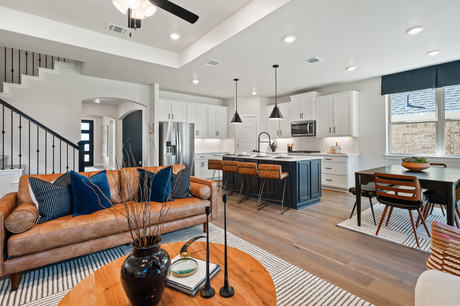 open great room with wood floors and ceiling fan