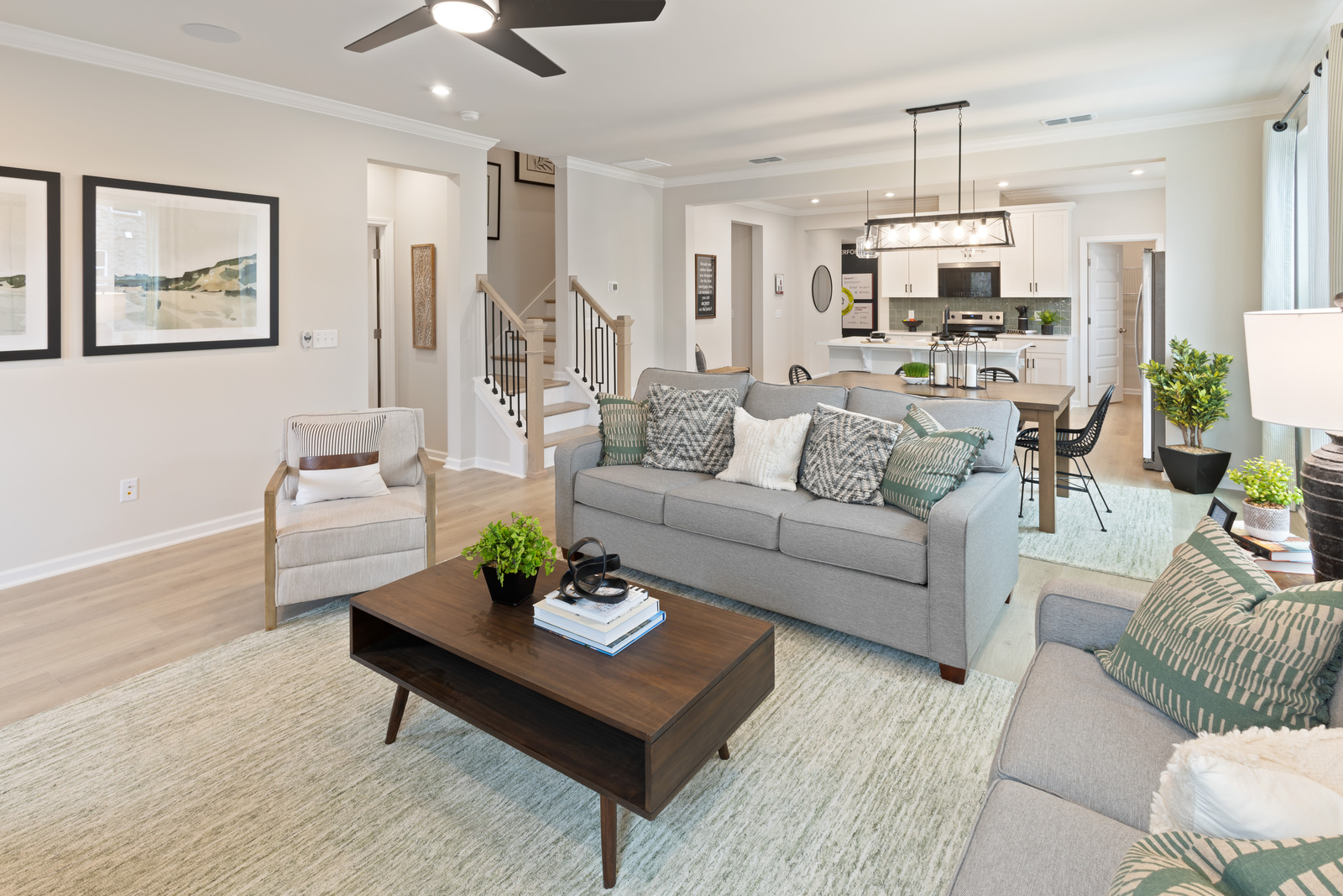 great room with fireplace, gray sofas, a coffee table, and a chair