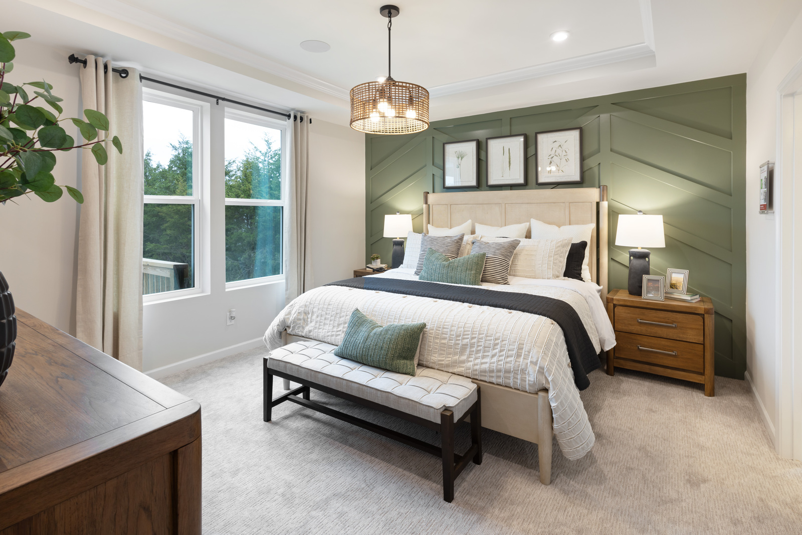 primary bedroom with green accent wall, bed, and nightstand