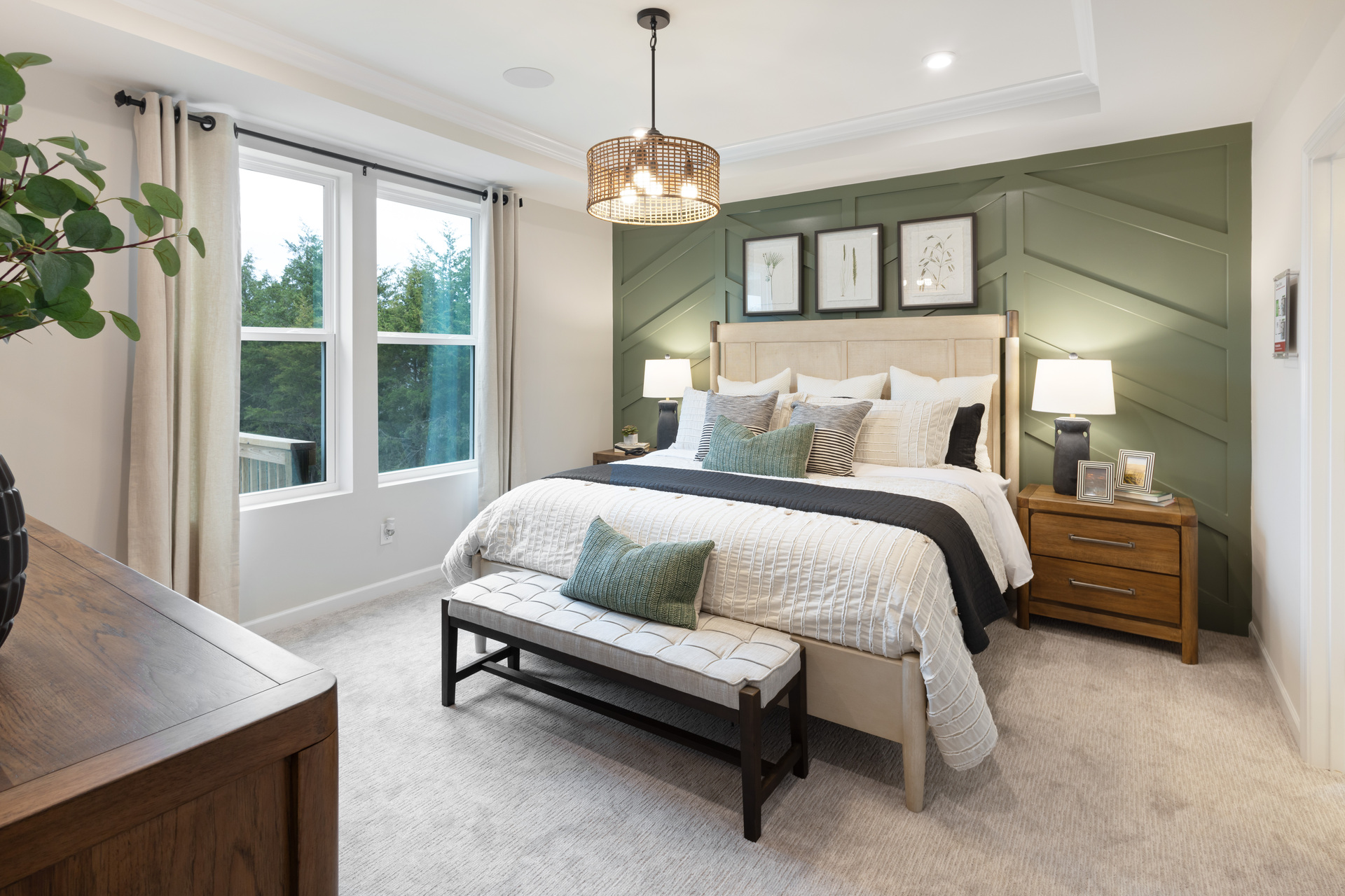 primary bedroom with green accent wall, bed, and nightstand
