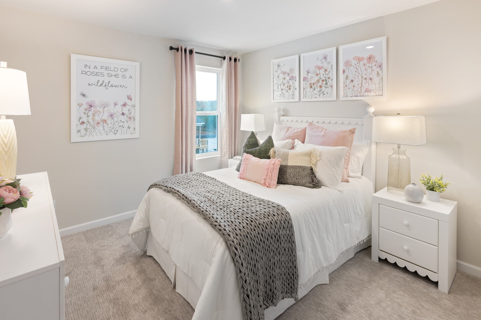 secondary bedroom with bed, nightstands, and large windows