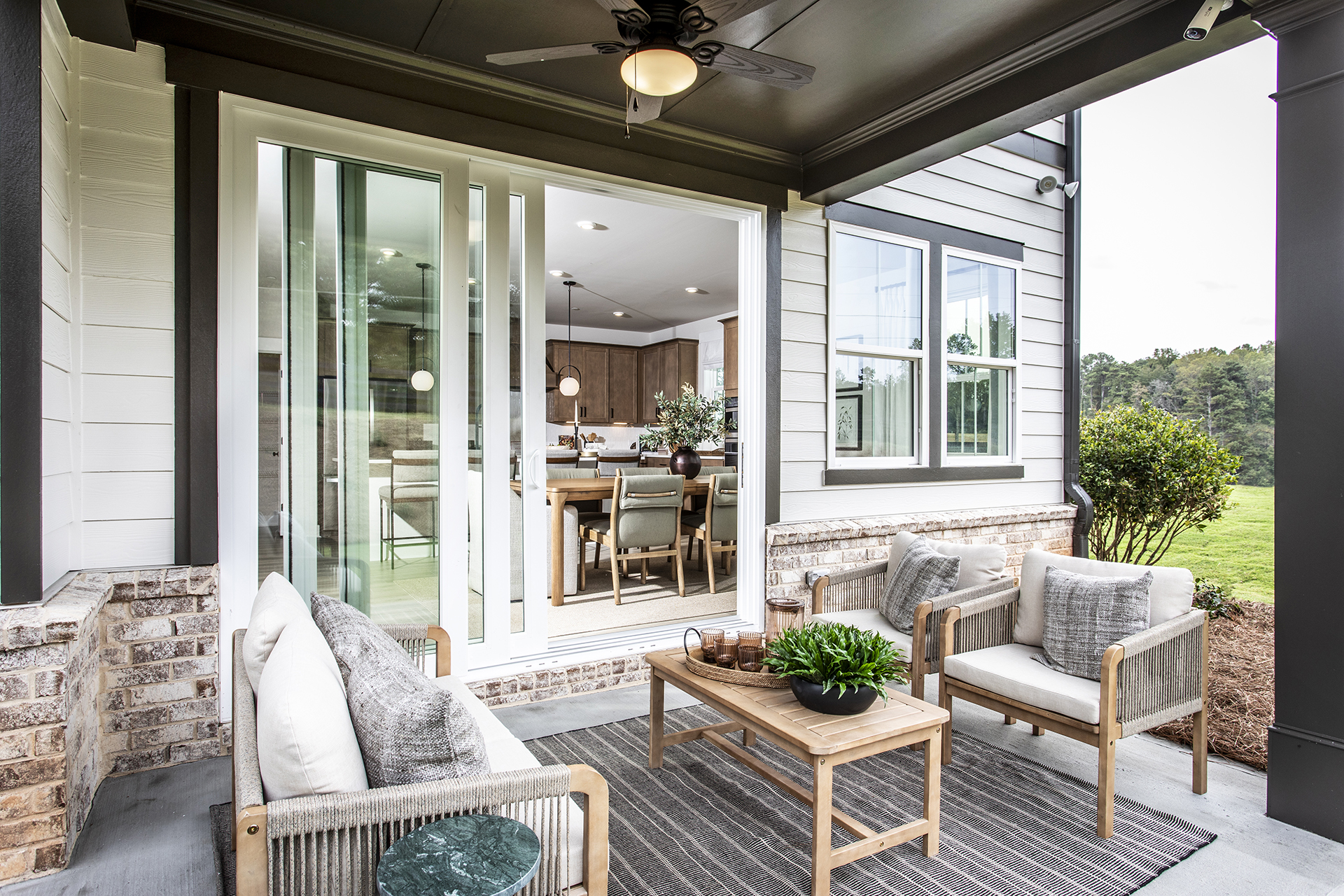 covered patio with patio furniture and views into home