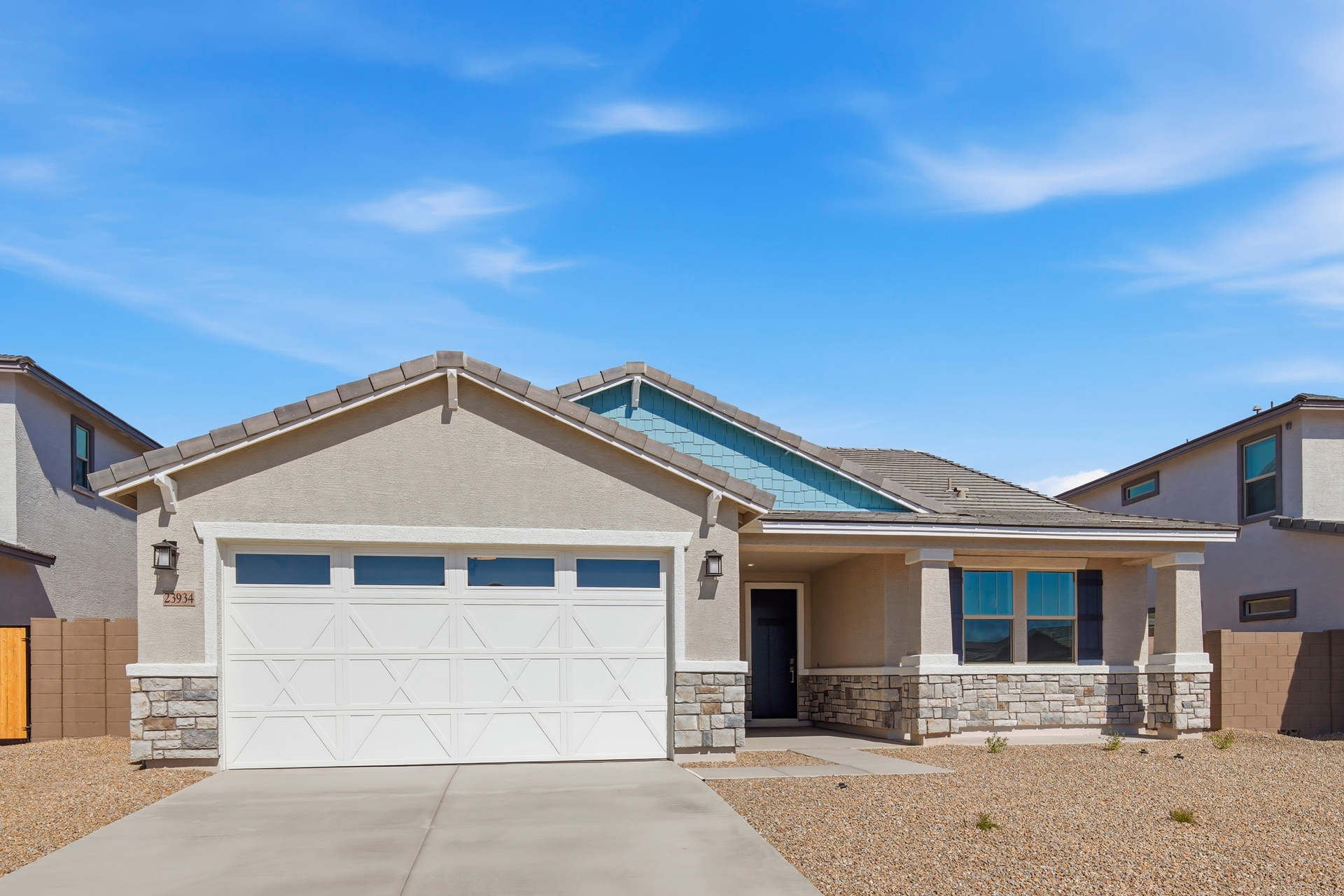 single-story single-family home with desert landscaping and concrete driveway