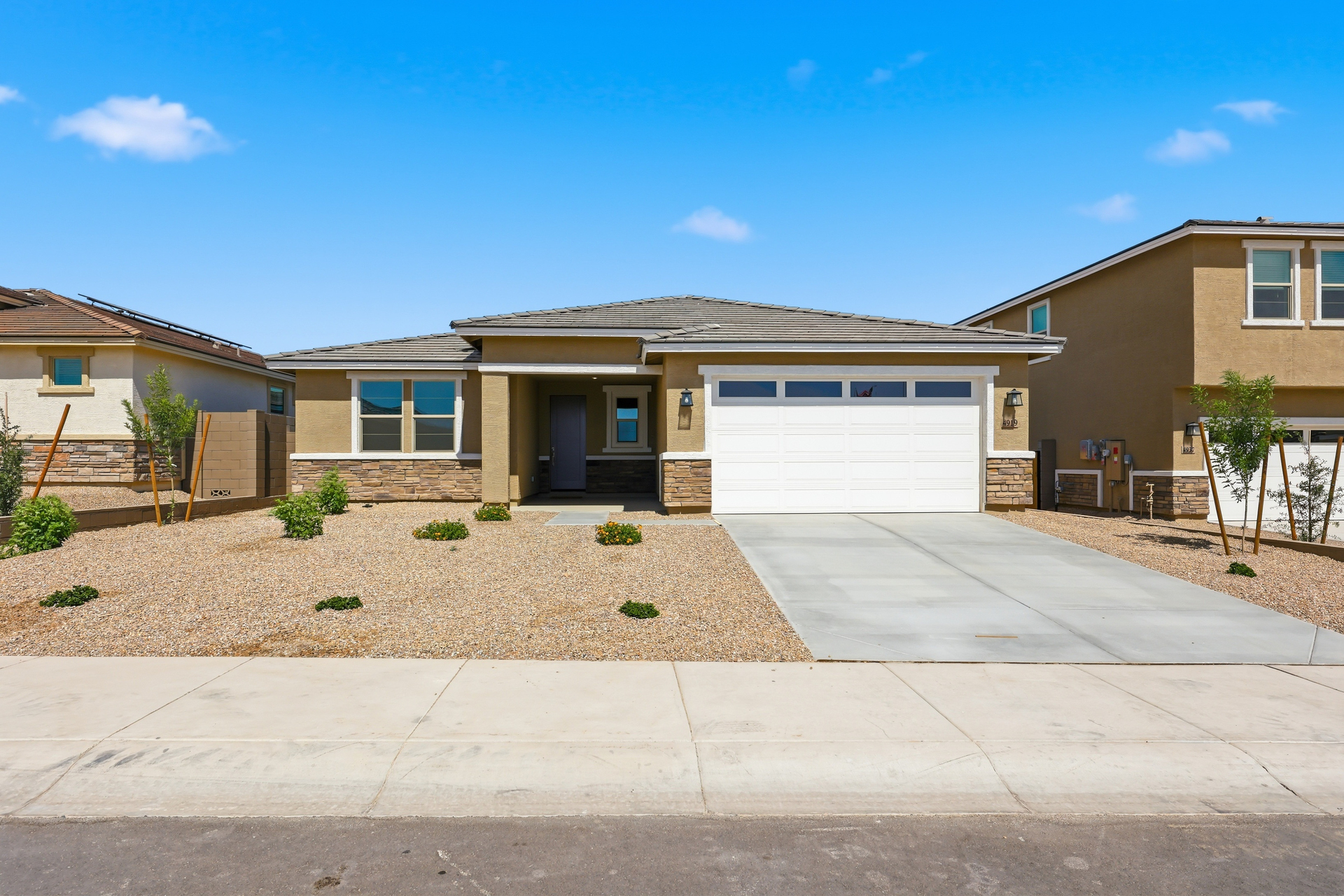 single-family single-story home with desert landscaping and concrete driveway