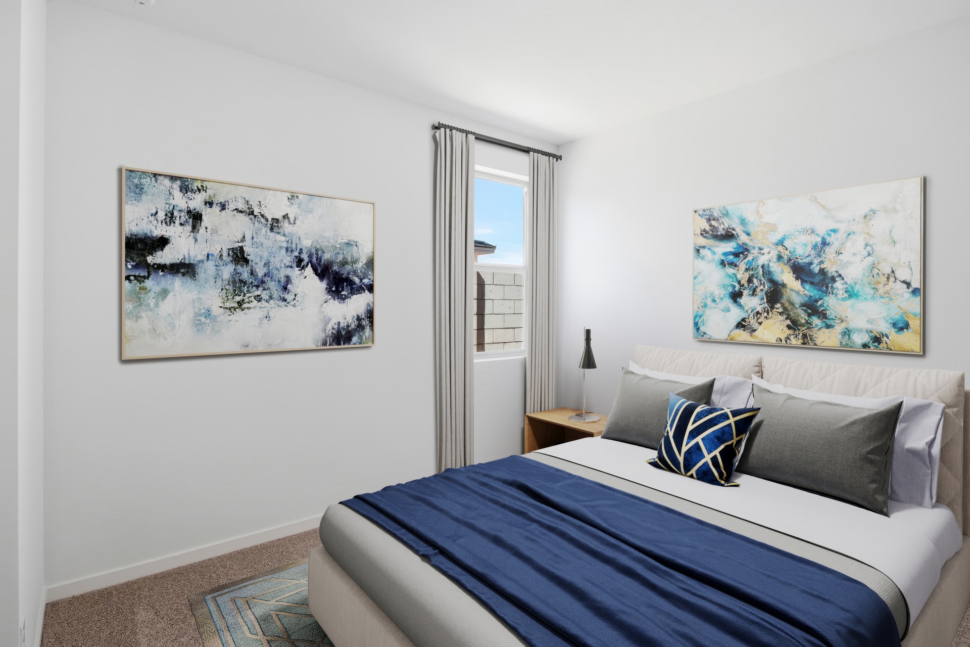 bedroom with a large bed, blue duvet cover, and blue abstract art