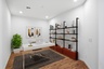 at home office with a white office desk, an indoor plant, and a brown rug