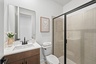 single sink vanity, water closet and shower